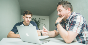Picture of two men with a laptop studying a Construction Training Scotland course.